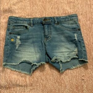 Jean shorts with rips in the legs